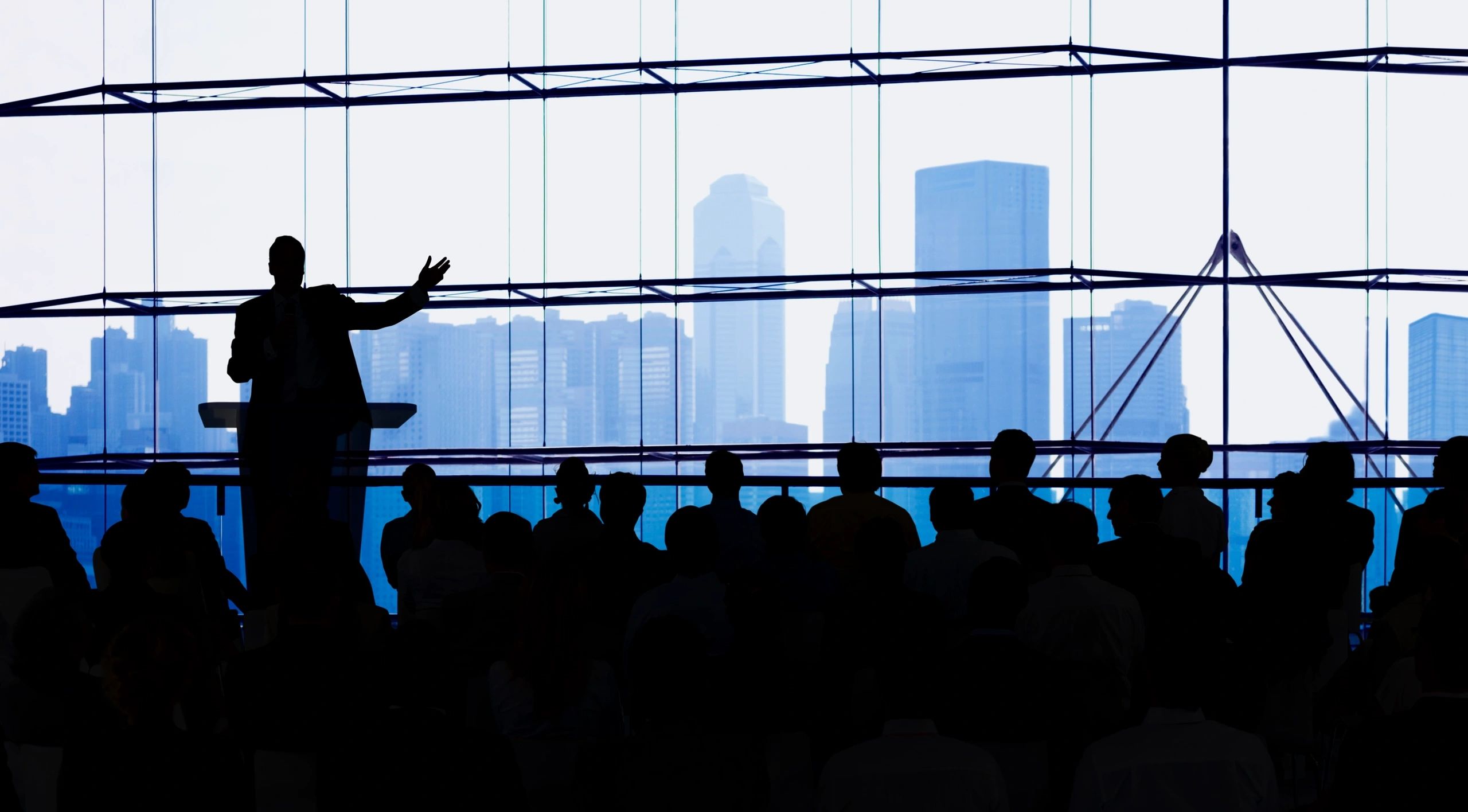 A man standing in front of a crowd with his arms outstretched.