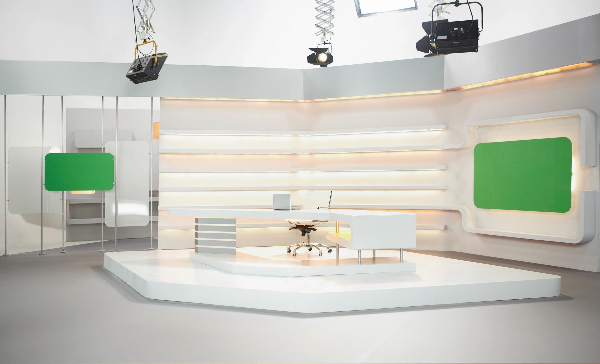 A television studio with white walls and green lighting.