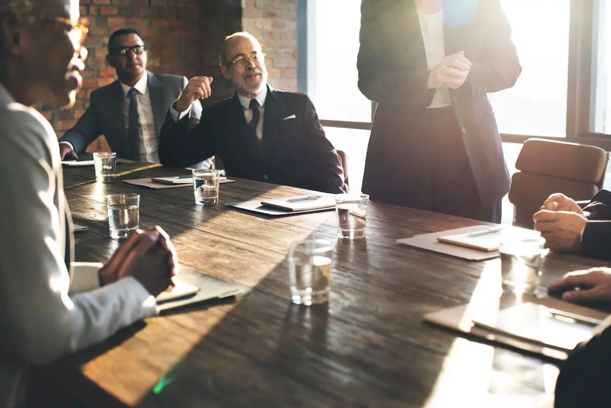 A group of people sitting at a table talking.